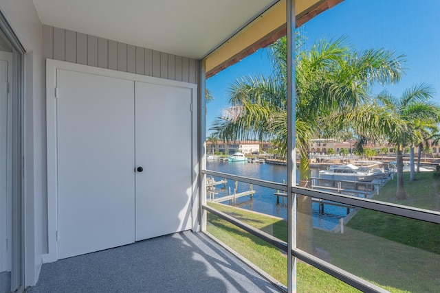 unfurnished sunroom featuring a water view