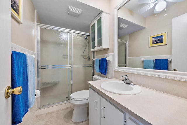 bathroom with walk in shower, vanity, ceiling fan, tile patterned flooring, and toilet