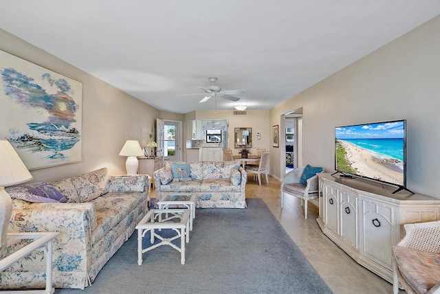 tiled living room featuring ceiling fan