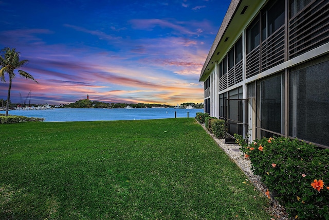 yard at dusk with a water view