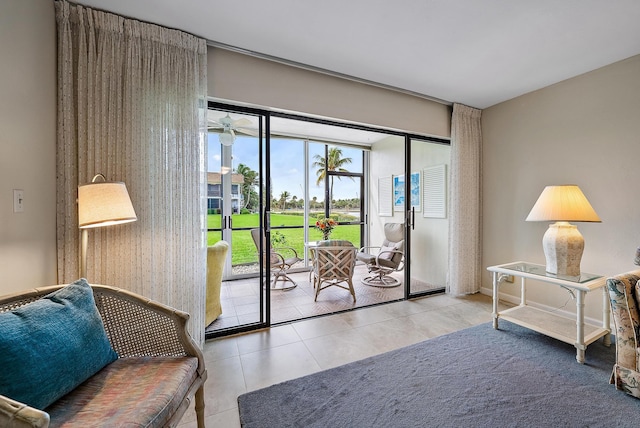 doorway to outside featuring tile patterned flooring and ceiling fan