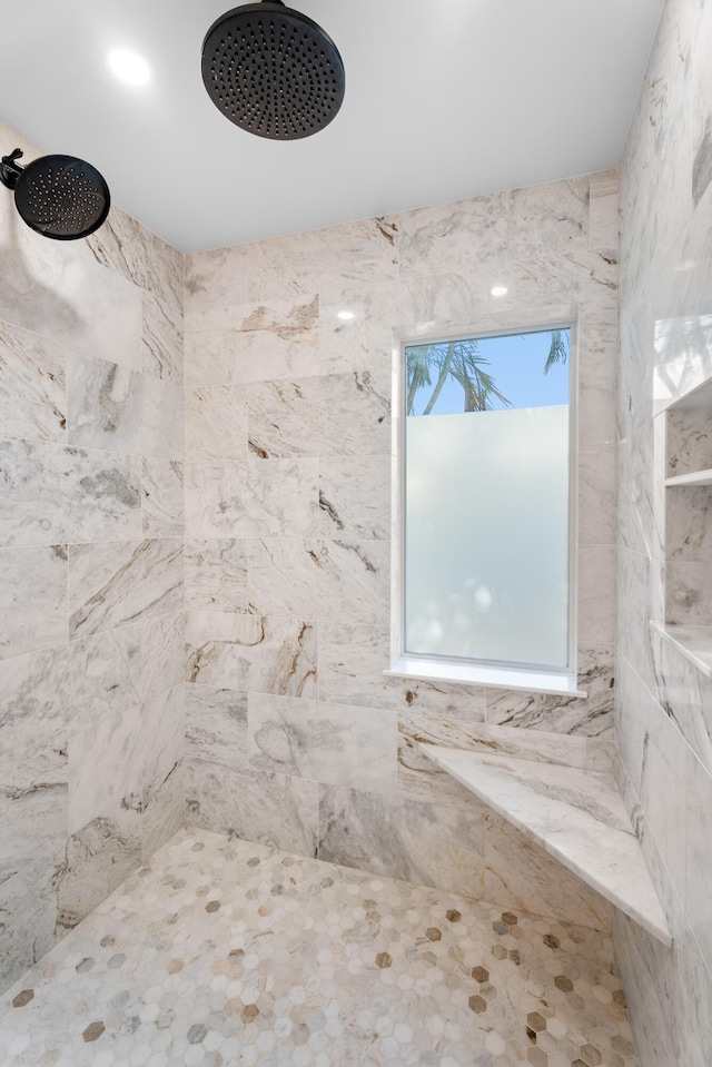 bathroom with a tile shower