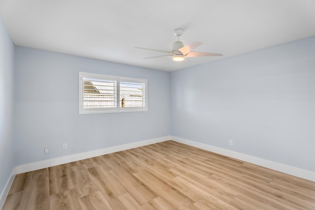 spare room with ceiling fan and light wood-type flooring