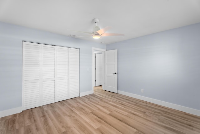 unfurnished bedroom with ceiling fan, a closet, and light hardwood / wood-style flooring