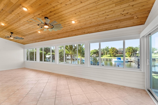 unfurnished sunroom with a water view, ceiling fan, wood ceiling, and vaulted ceiling