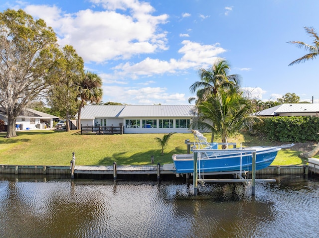 dock area with a yard and a water view