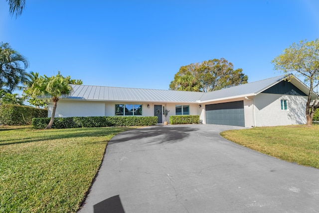 single story home with a garage and a front yard