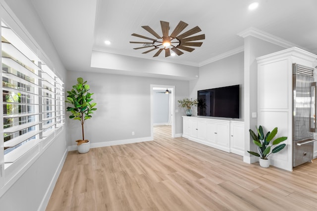 unfurnished living room featuring ornamental molding, ceiling fan, and light hardwood / wood-style flooring