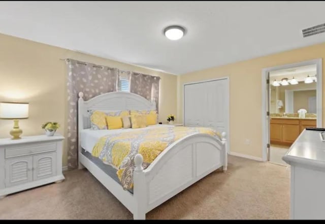 carpeted bedroom with connected bathroom