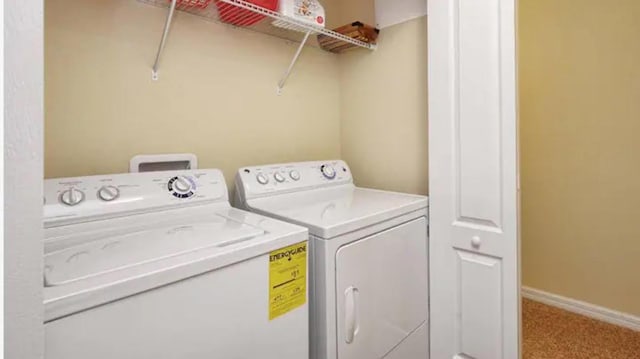 laundry room with carpet floors and separate washer and dryer