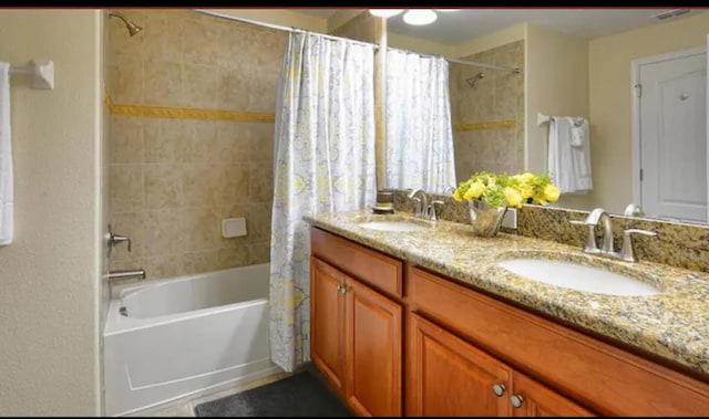 bathroom with vanity and shower / bathtub combination with curtain