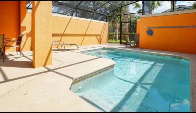 view of pool featuring a lanai and a patio area