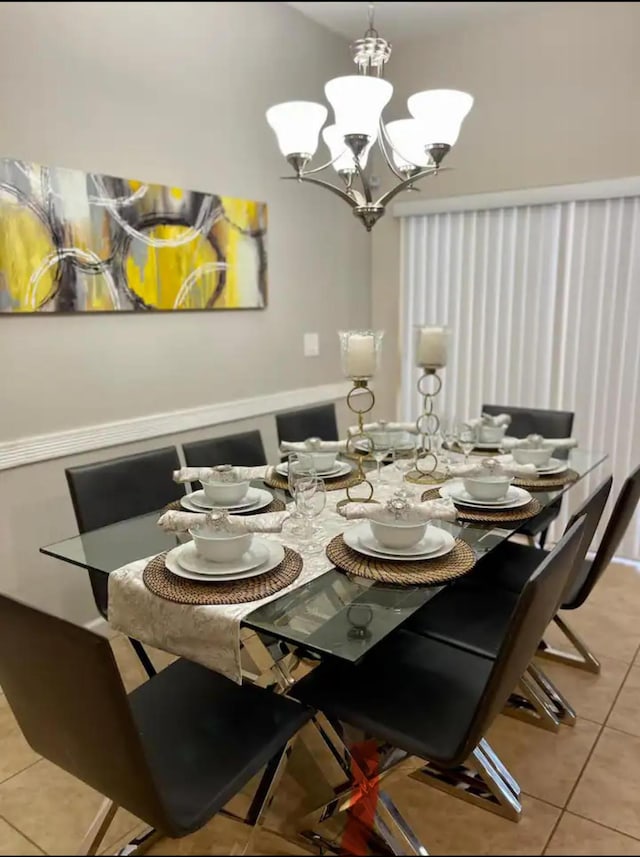 tiled dining area with an inviting chandelier