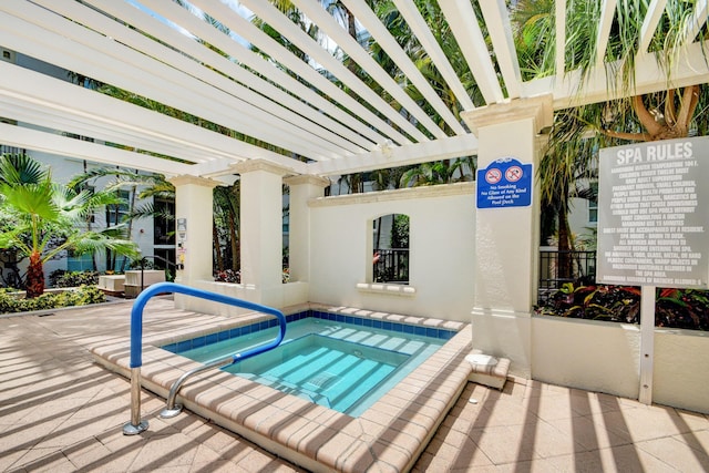 view of swimming pool with a pergola and a hot tub