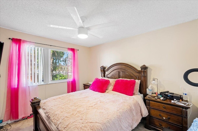 bedroom with ceiling fan, light carpet, and a textured ceiling