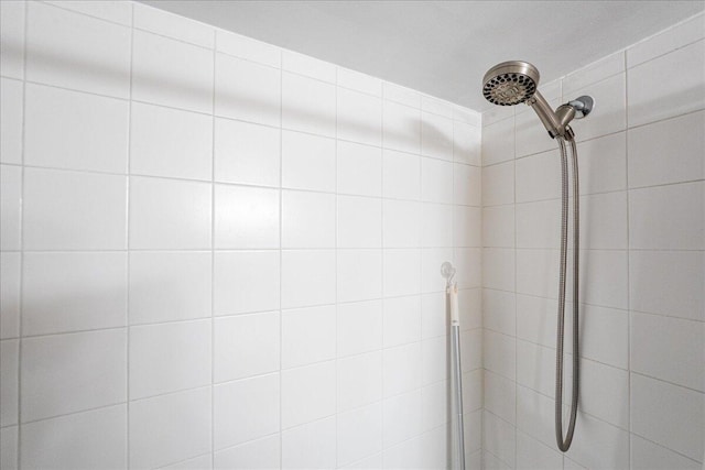 interior details featuring a tile shower