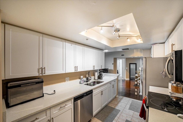 kitchen with light hardwood / wood-style floors, sink, white cabinetry, and stainless steel appliances