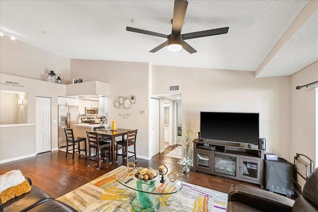 living room featuring ceiling fan, dark hardwood / wood-style flooring, high vaulted ceiling, and a textured ceiling