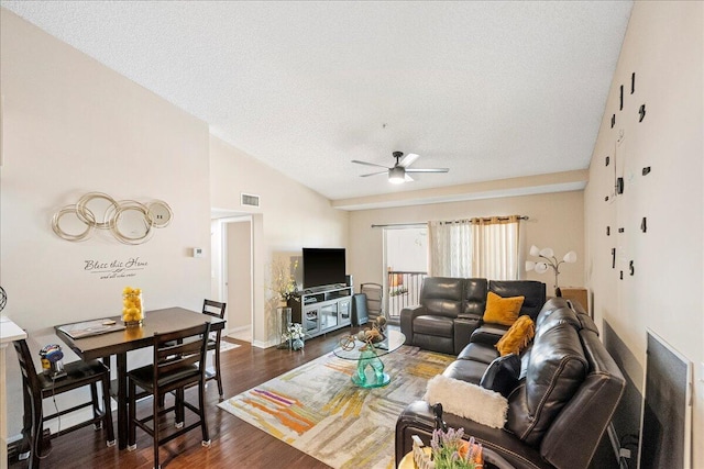 living room with a textured ceiling, high vaulted ceiling, ceiling fan, and dark wood-type flooring