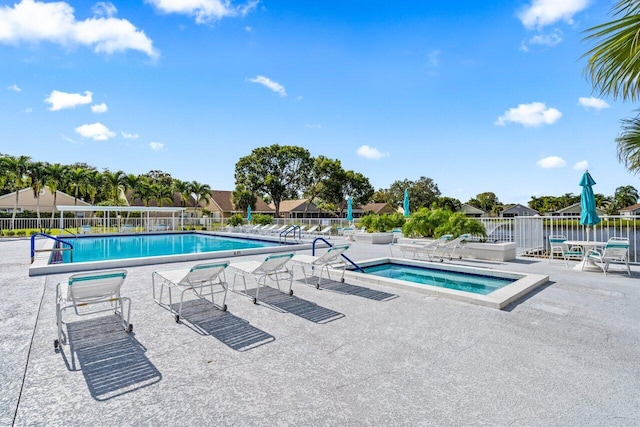 view of pool featuring a patio area and a community hot tub