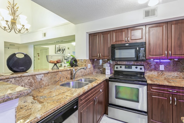 kitchen featuring sink, stainless steel appliances, tasteful backsplash, and a chandelier