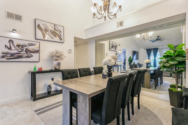 dining space featuring ceiling fan with notable chandelier, lofted ceiling, and light tile patterned flooring