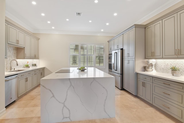 kitchen with backsplash, sink, a center island, and appliances with stainless steel finishes