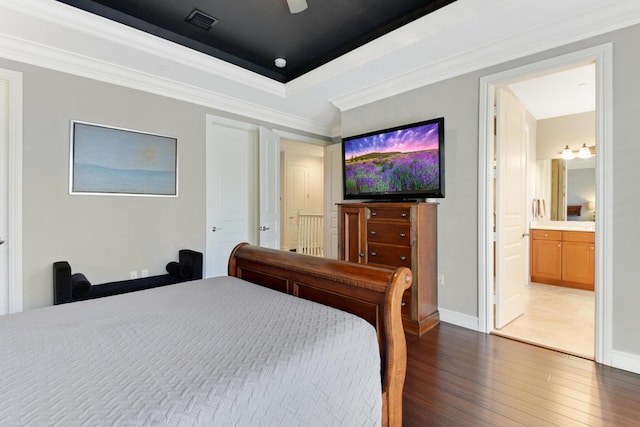 bedroom with ensuite bathroom, ceiling fan, dark wood-type flooring, and ornamental molding