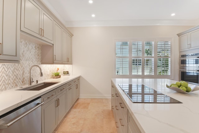 kitchen featuring backsplash, light stone counters, ornamental molding, stainless steel appliances, and sink