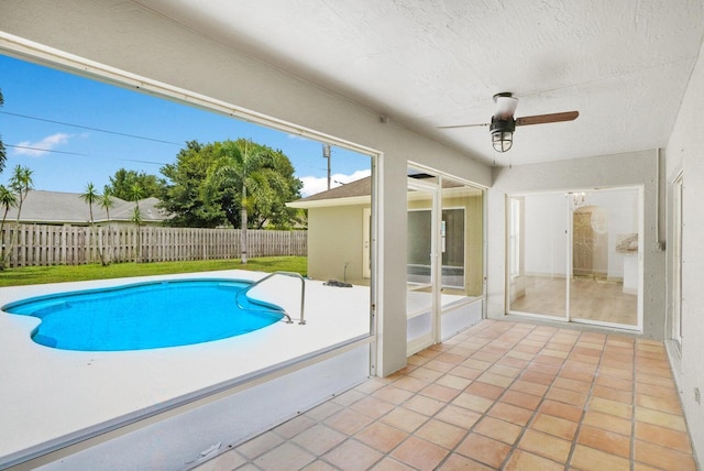 view of swimming pool featuring ceiling fan