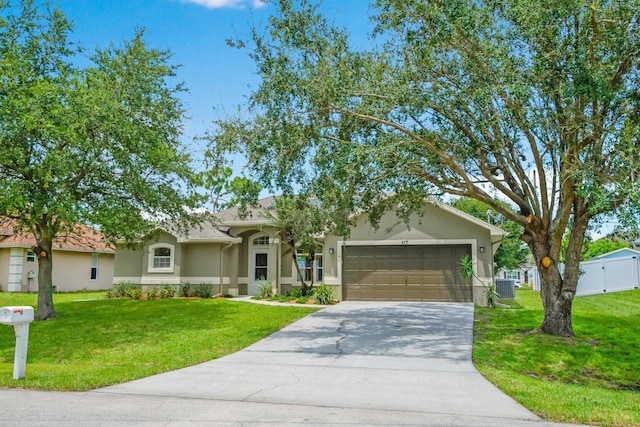 ranch-style home with central AC unit, a front yard, and a garage