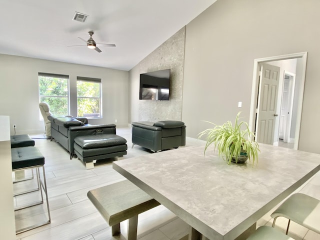 living room with light hardwood / wood-style floors, vaulted ceiling, and ceiling fan