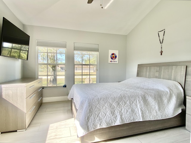 bedroom featuring ceiling fan and vaulted ceiling