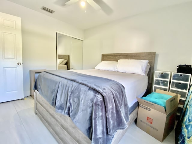 tiled bedroom with a closet and ceiling fan