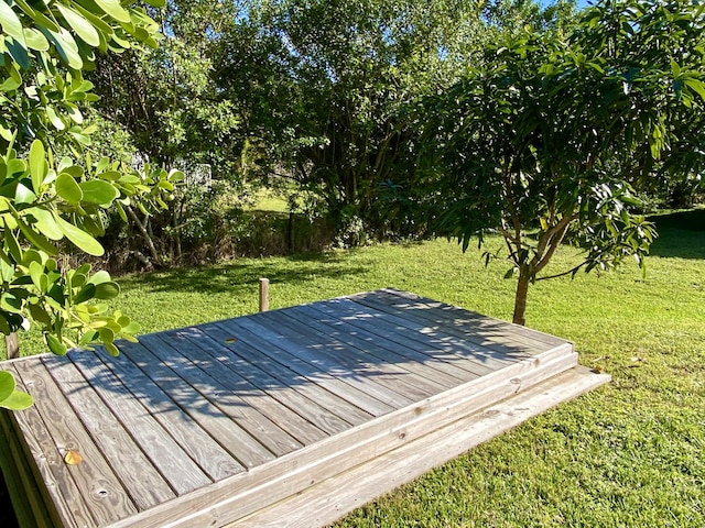 wooden deck featuring a yard