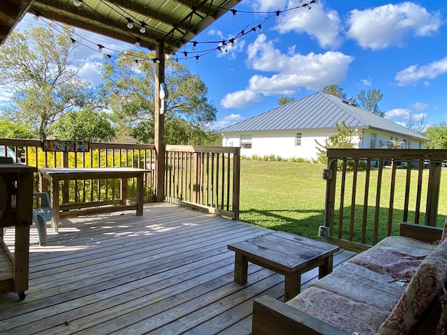 wooden terrace featuring a yard