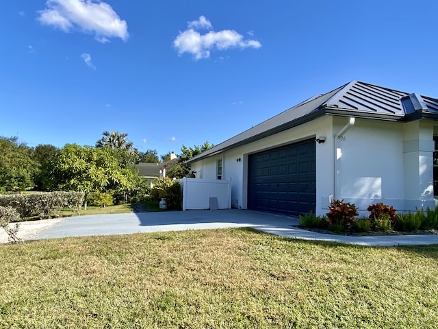 view of home's exterior with a yard and a garage