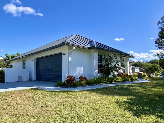 view of home's exterior featuring a lawn and a garage