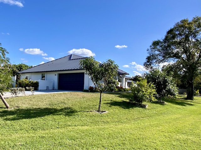 view of side of property with a garage and a yard