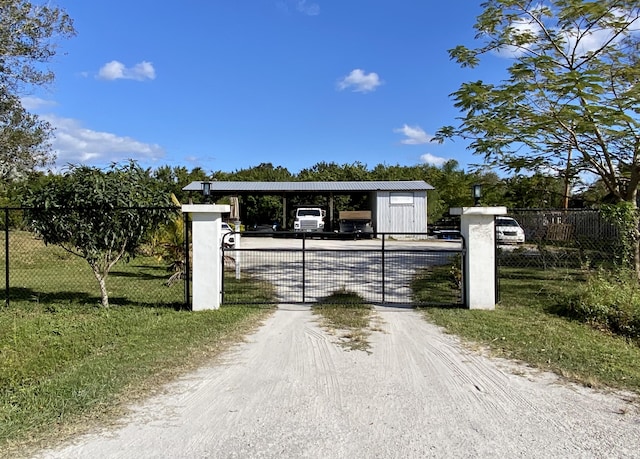 view of gate featuring a yard