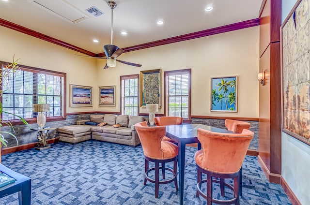 dining room featuring crown molding, ceiling fan, and dark colored carpet