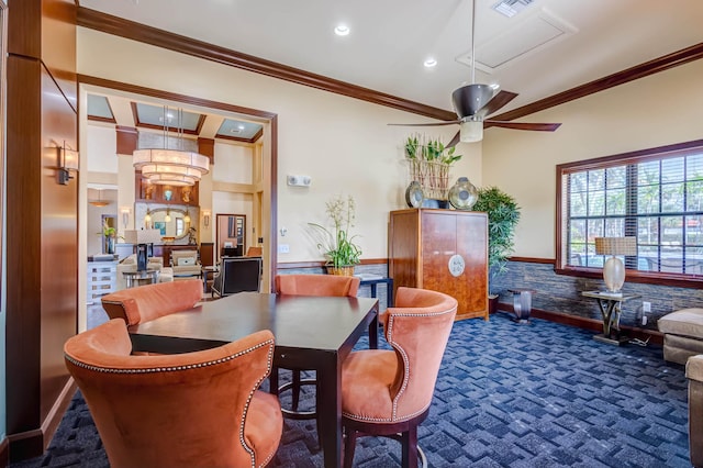 interior space with dark colored carpet, ceiling fan, and ornamental molding