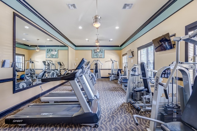 gym featuring crown molding and dark carpet