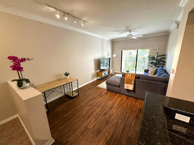 living room featuring crown molding, dark hardwood / wood-style flooring, ceiling fan, and a textured ceiling