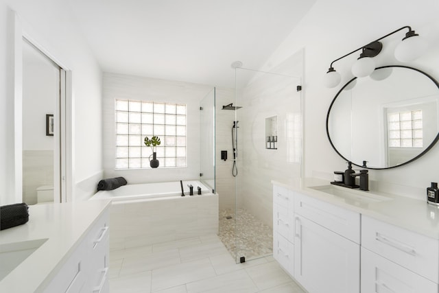 bathroom featuring tile patterned floors, plenty of natural light, vanity, and independent shower and bath