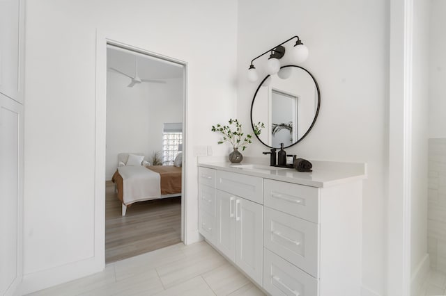 bathroom with vanity, hardwood / wood-style flooring, and ceiling fan