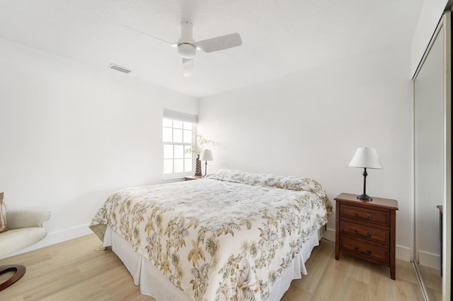 bedroom featuring light wood-type flooring, a closet, and ceiling fan