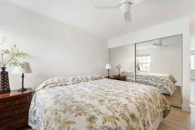 bedroom with ceiling fan, a closet, and light hardwood / wood-style flooring