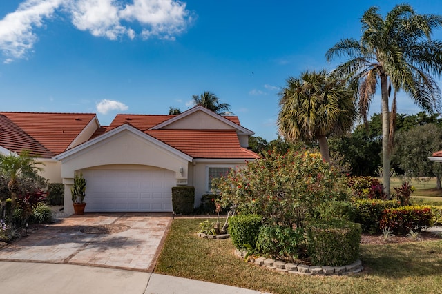 view of front of home featuring a garage and a front lawn