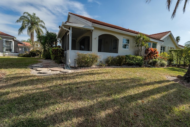 view of side of property with a yard